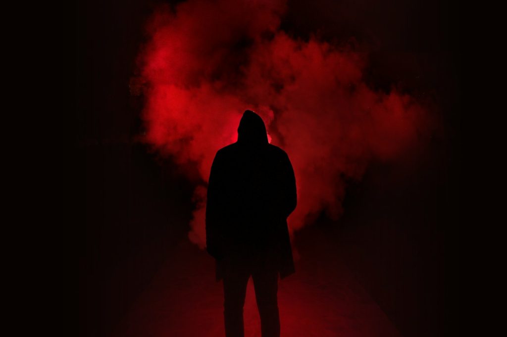 silhouette of person on a dark place with smoke
